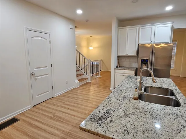 a kitchen with granite countertop a sink and a stove top oven