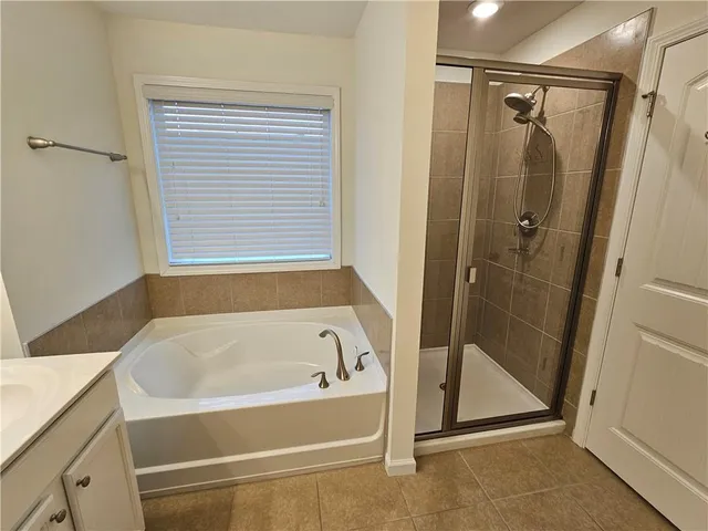 a white bath tub sitting next to a shower