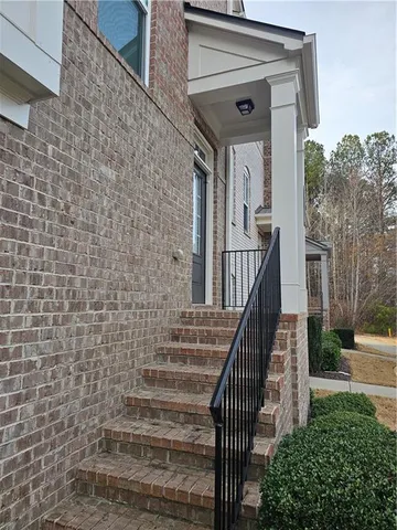 a view of front door of house with stairs