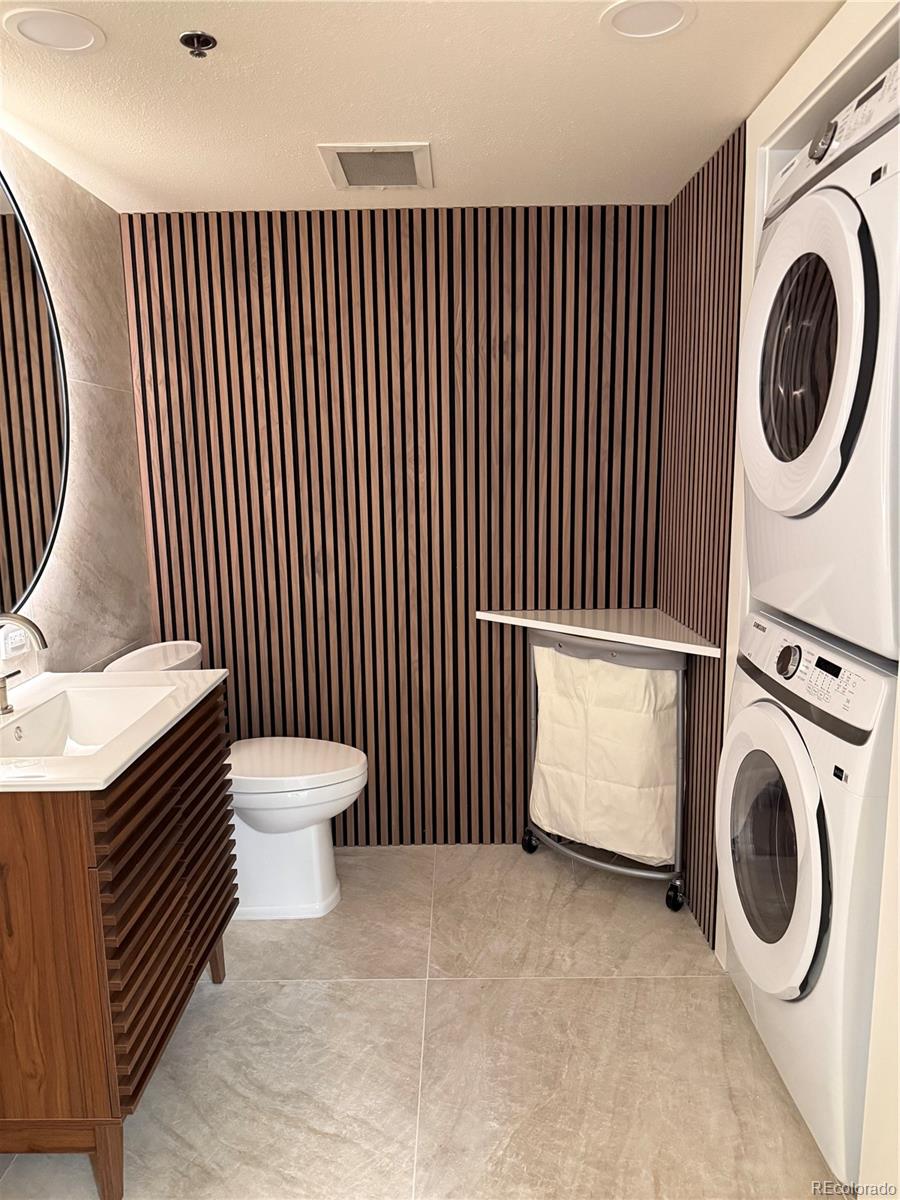 350 Detroit Street, Unit 209 Denver, CO 80206 - Photo 11 of 12 a view of a bathroom with washing machine and racks