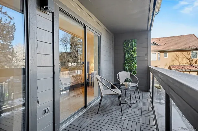 a view of a balcony filled with furniture