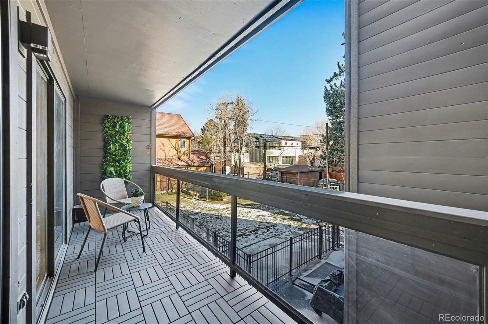 350 Detroit Street, Unit 209 Denver, CO 80206 - Photo 20 of 23 a view of balcony with chairs and wooden fence