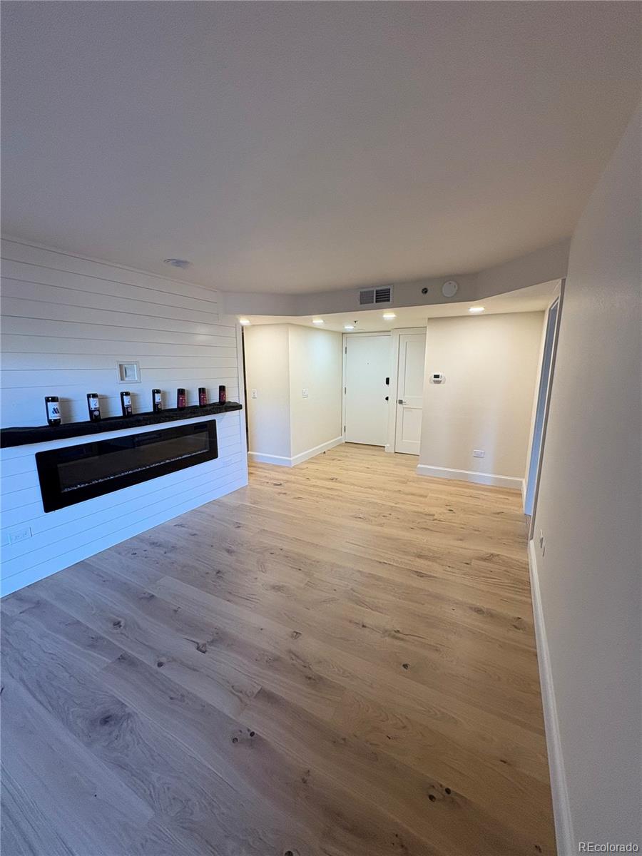 350 Detroit Street, Unit 209 Denver, CO 80206 - Photo 2 of 12 a view of empty room with wooden floor