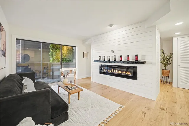 a living room with furniture and a floor to ceiling window