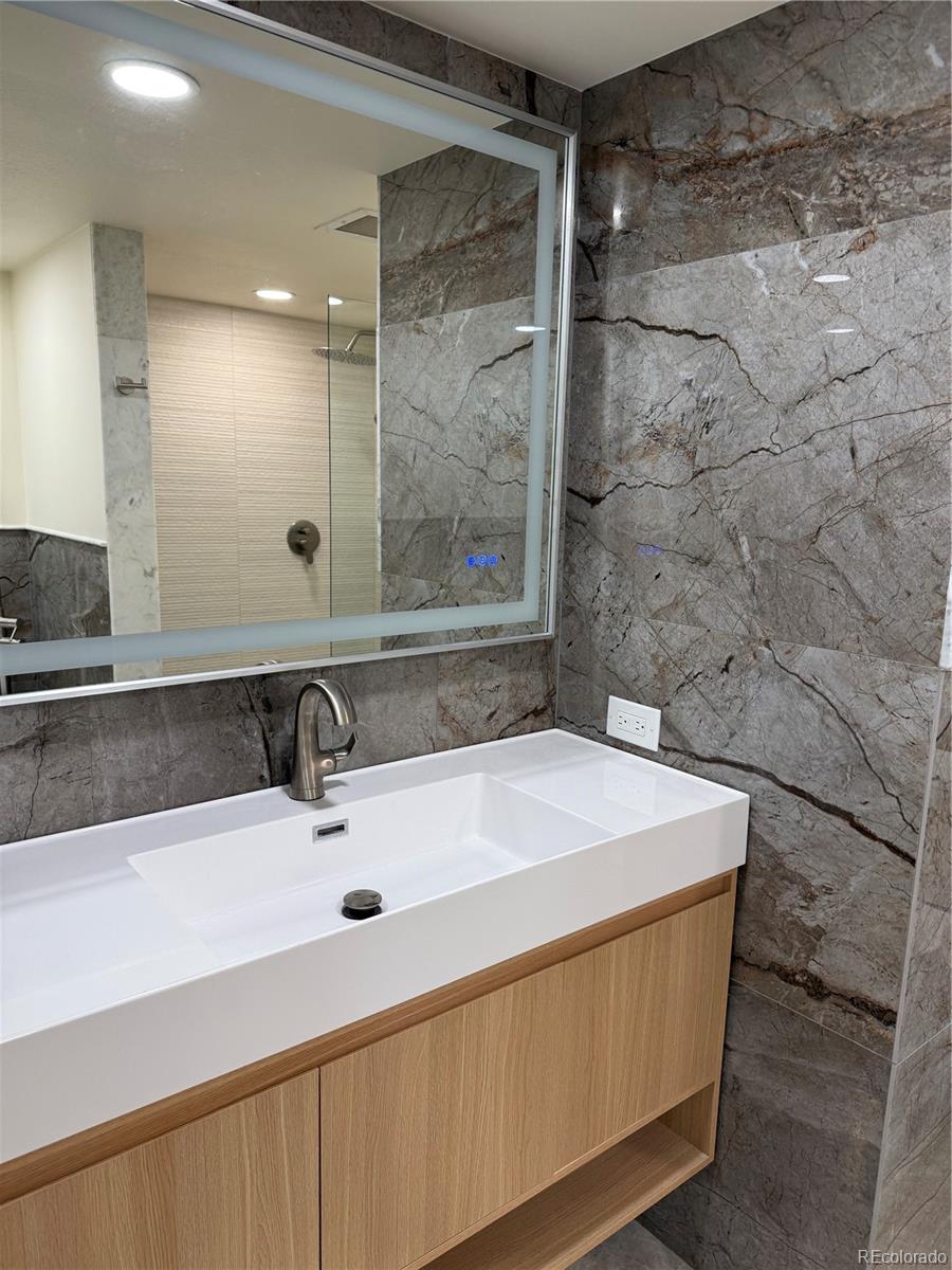 350 Detroit Street, Unit 209 Denver, CO 80206 - Photo 6 of 12 a bathroom with a sink and a mirror