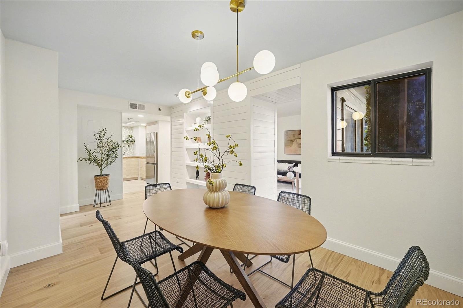 350 Detroit Street, Unit 209 Denver, CO 80206 - Photo 8 of 23 a view of a dining room with furniture and wooden floor