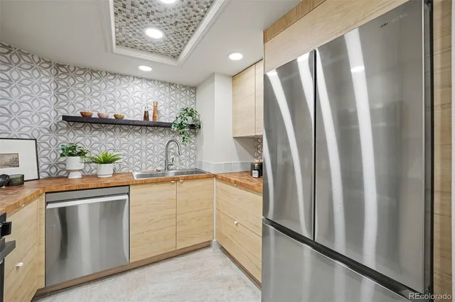 a kitchen with stainless steel appliances granite countertop a refrigerator and a sink