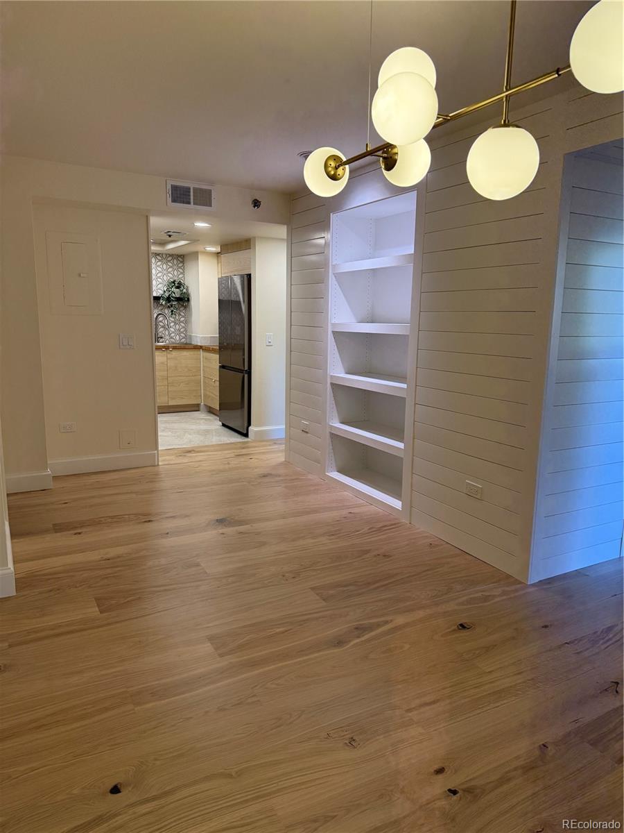 350 Detroit Street, Unit 209 Denver, CO 80206 - Photo 9 of 12 a view of a livingroom with wooden floor