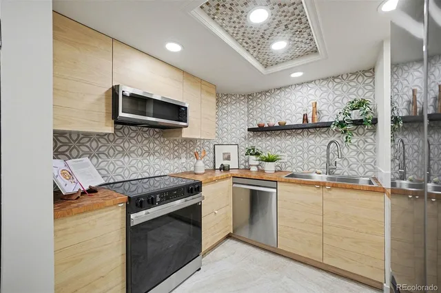 a kitchen with stainless steel appliances granite countertop a sink and cabinets