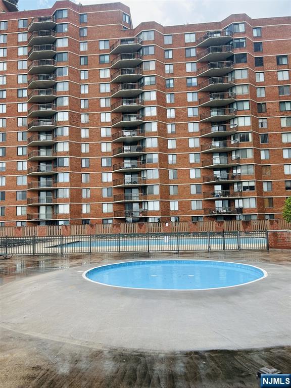 1040 Harmon Cove Tower, Unit 1040 Secaucus, NJ 07094 - Photo 14 of 15 a view of a building with a swimming pool