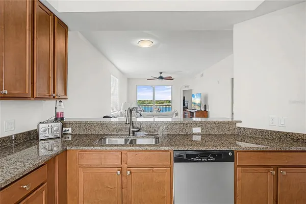 a kitchen with stainless steel appliances granite countertop a sink and cabinets