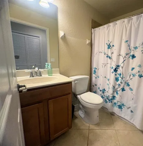 a bathroom with a sink toilet and a mirror