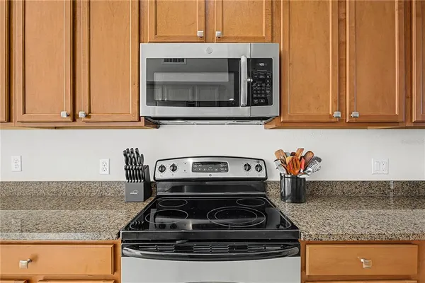 a kitchen with granite countertop a stove and a sink