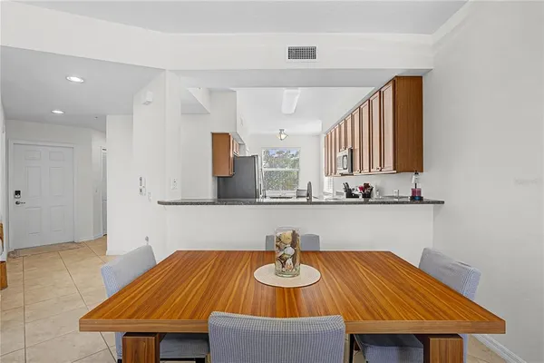 a room with a table chairs and wooden floor