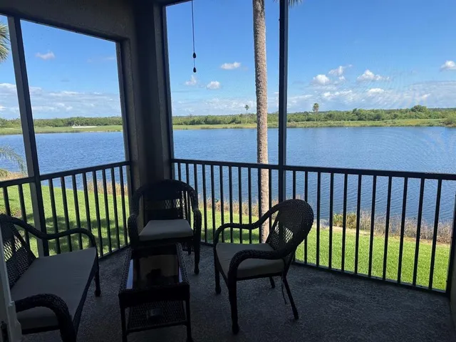 a view of a chairs and table in the balcony