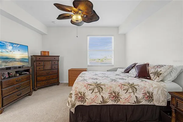 a bedroom with a bed and a television