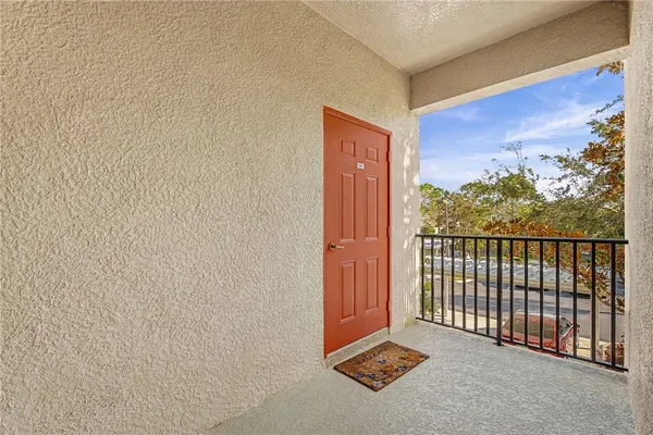a view of a room with a door and wooden floor