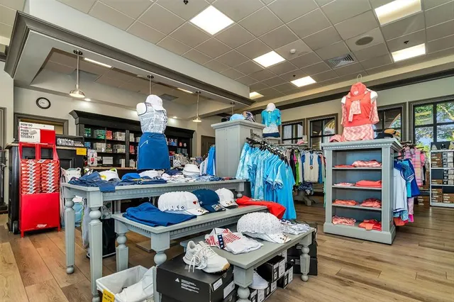 a view of a kitchen with stainless steel appliances kitchen island granite countertop a refrigerator and a sink