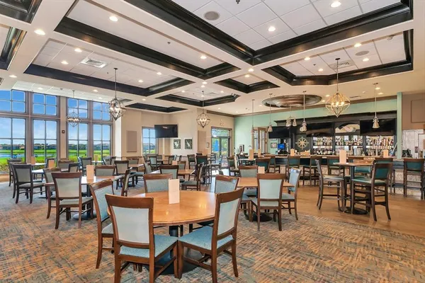 a living room with lots of furniture and kitchen view