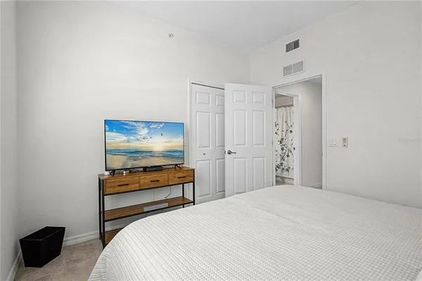 a bedroom with a bed and a couch