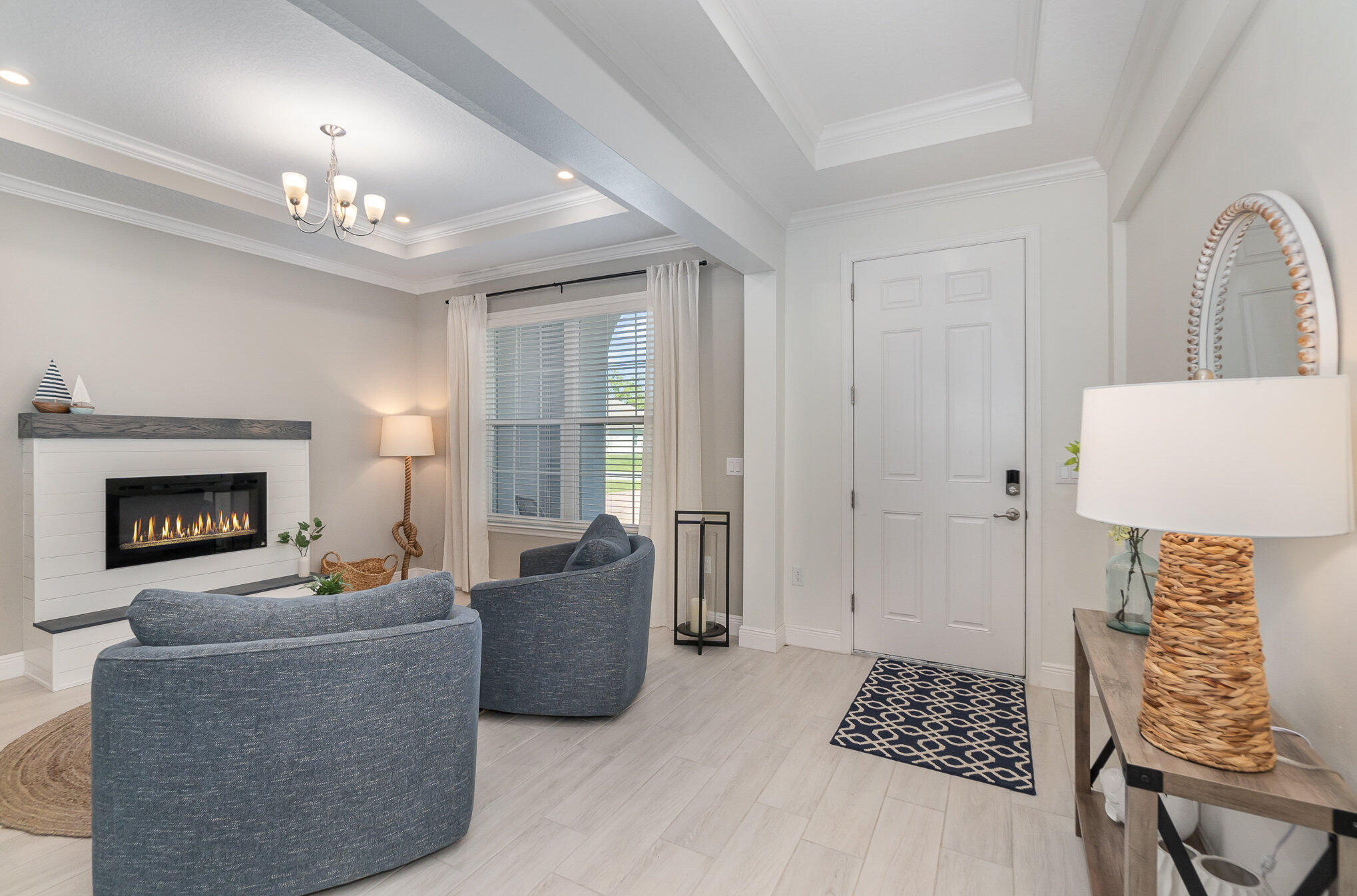 1780 Indria Lane Malabar, FL 32950 - Photo 13 of 35 a living room with furniture a chandelier and a fireplace