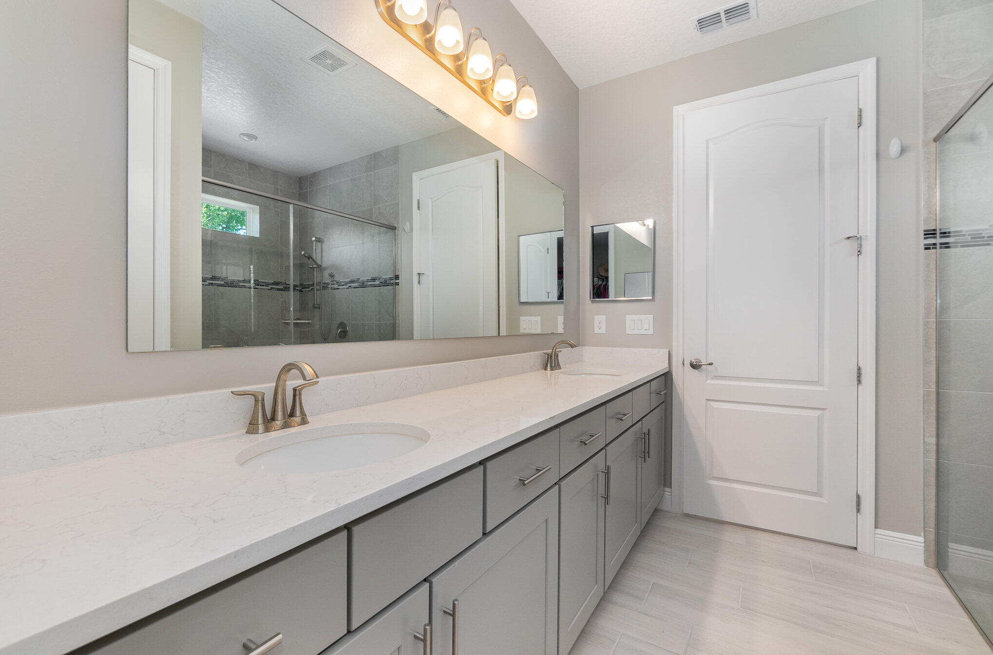 1780 Indria Lane Malabar, FL 32950 - Photo 17 of 35 a bathroom with a double vanity sink and mirror