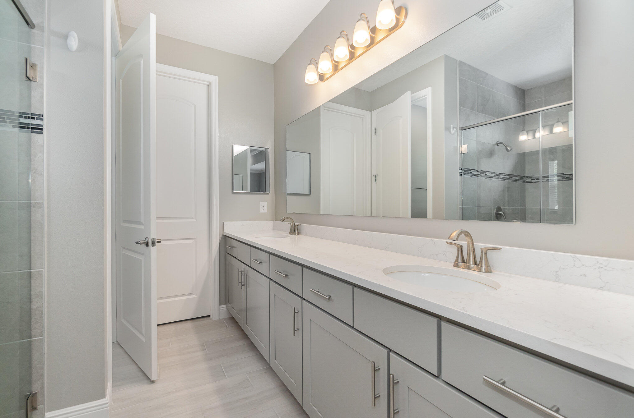 1780 Indria Lane Malabar, FL 32950 - Photo 18 of 35 a bathroom with a double vanity sink and a mirror