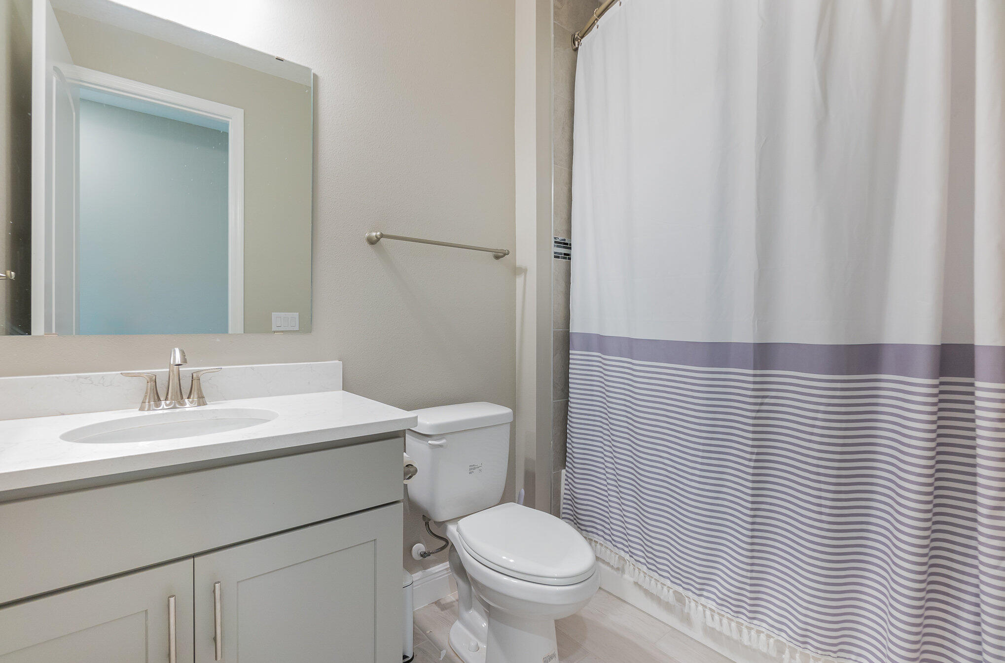 1780 Indria Lane Malabar, FL 32950 - Photo 20 of 35 a bathroom with a granite countertop toilet a sink and a mirror