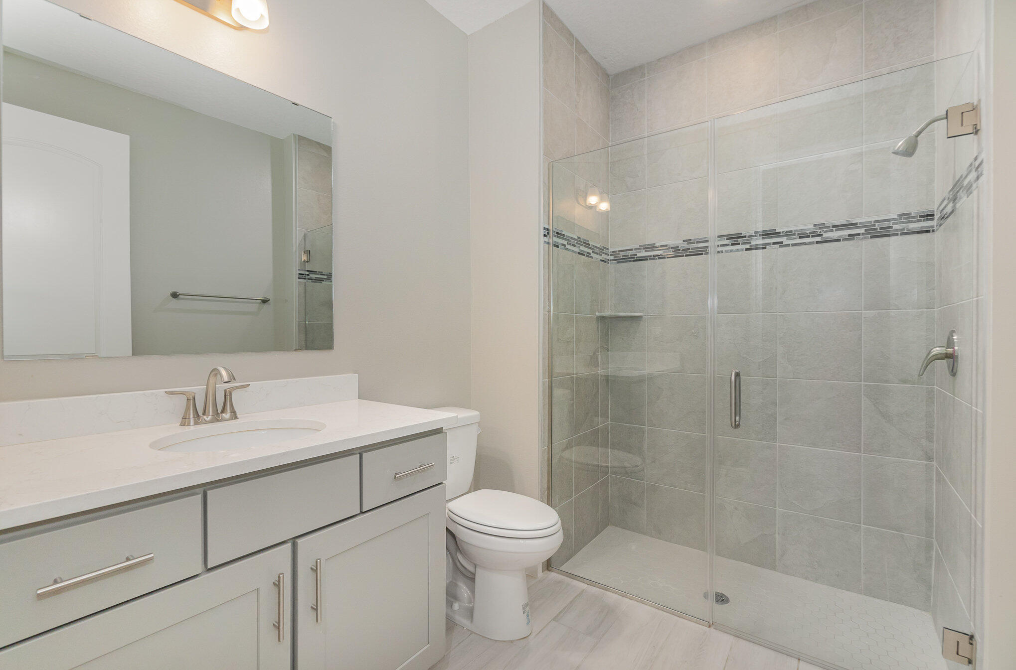 1780 Indria Lane Malabar, FL 32950 - Photo 23 of 35 a bathroom with a shower sink vanity mirror and toilet
