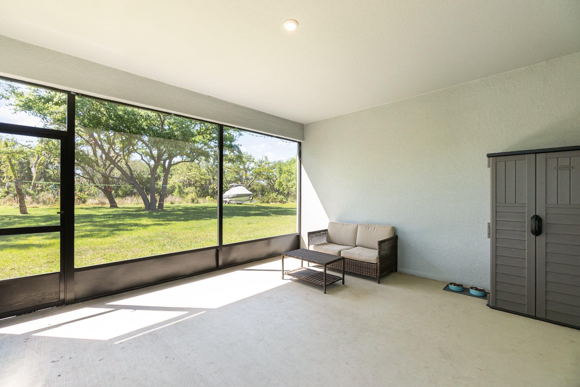 1780 Indria Lane Malabar, FL 32950 - Photo 30 of 35 a living room with furniture and floor to ceiling window