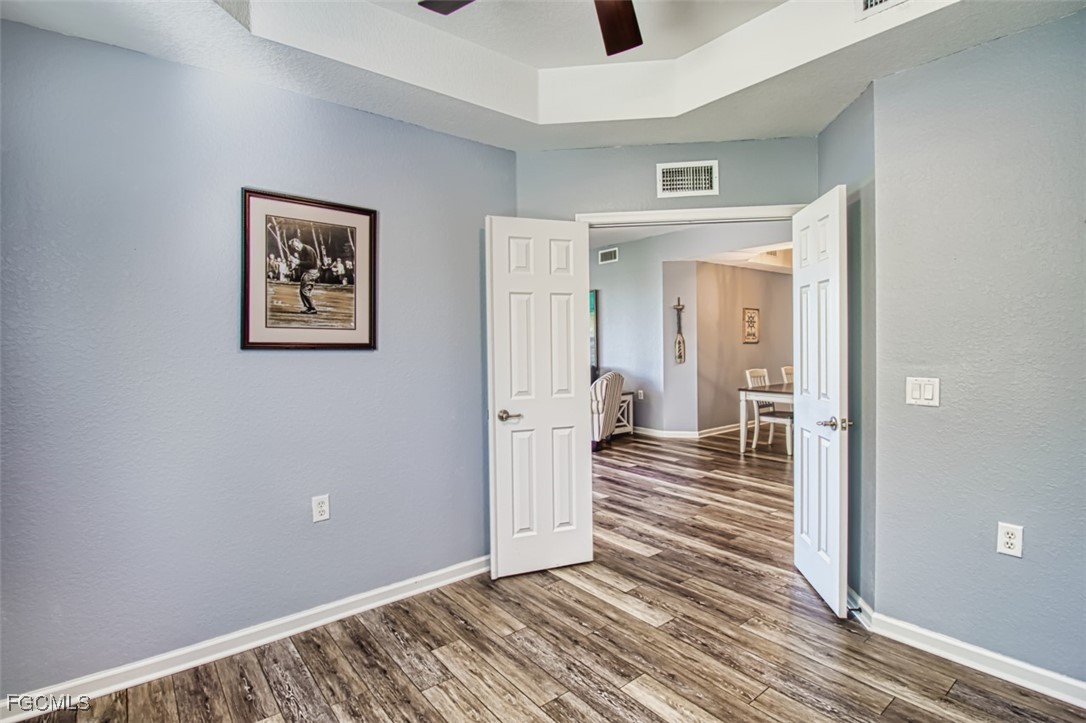 3111 Meandering Way, Unit 101 Fort Myers, FL 33905 - Photo 13 of 50 a view of a hallway with wooden floor and closet