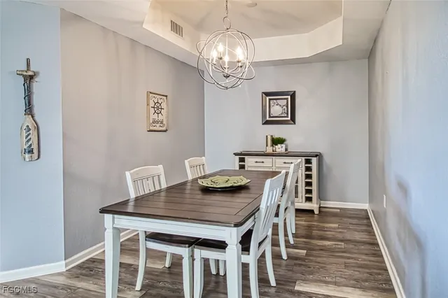 a view of a dining room with furniture and chandelier