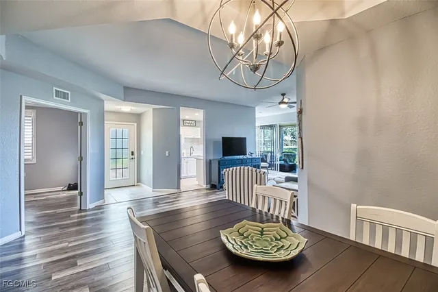 a view of a livingroom with furniture wooden floor and a chandelier