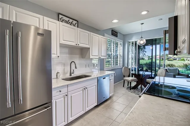 a kitchen with stainless steel appliances granite countertop a refrigerator sink and cabinets