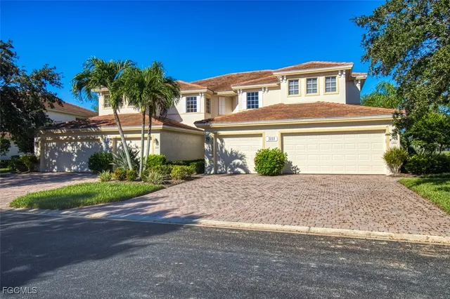 a front view of a house with a yard and a garage