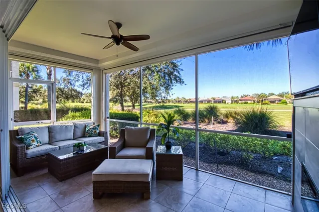 a living room with furniture and a floor to ceiling window