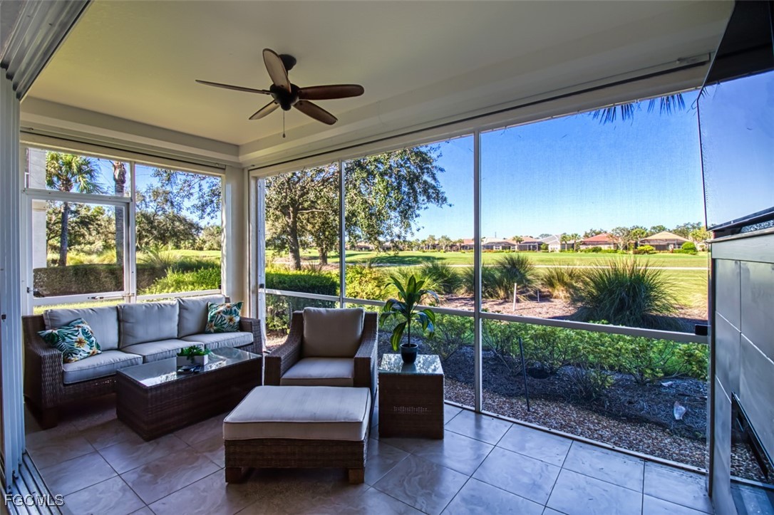 3111 Meandering Way, Unit 101 Fort Myers, FL 33905 - Photo 21 of 50 a living room with furniture and a floor to ceiling window