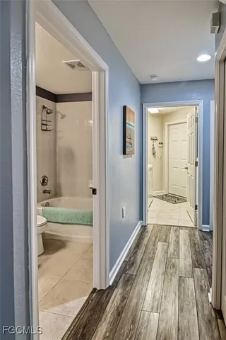 a bathroom with a glass shower door and a bathtub