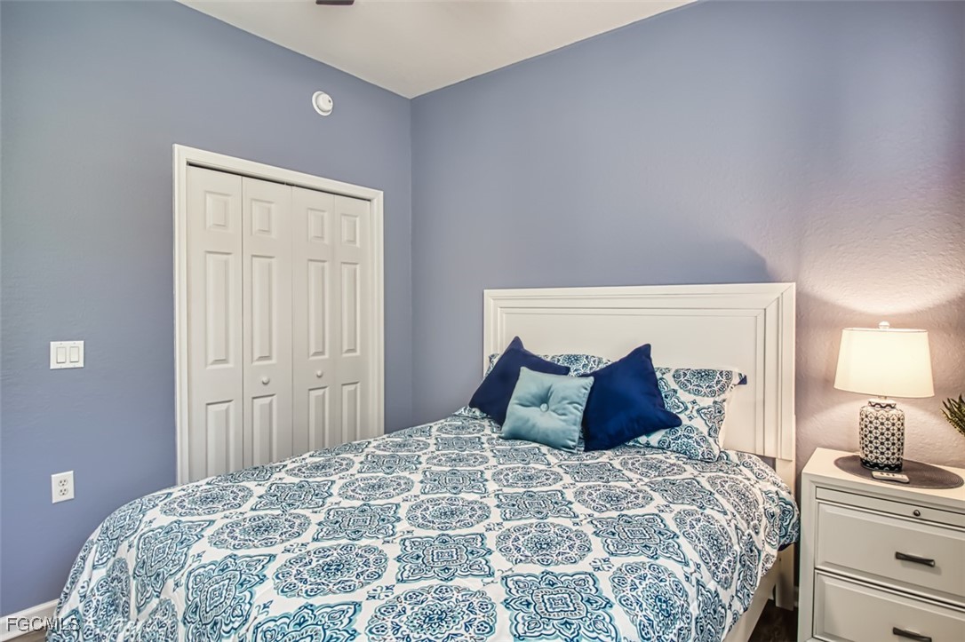 3111 Meandering Way, Unit 101 Fort Myers, FL 33905 - Photo 30 of 50 a bedroom with a large bed and a lamp