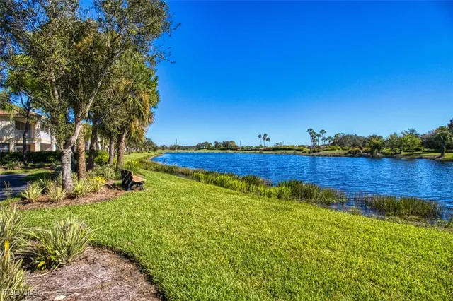 a view of a lake with houses in the back