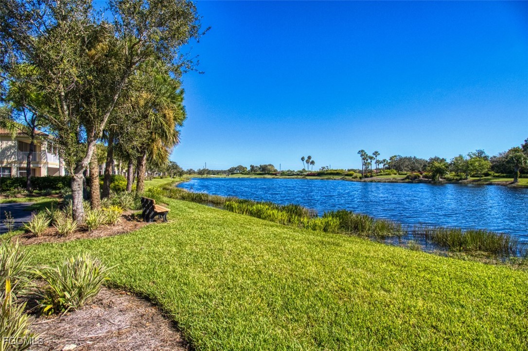 3111 Meandering Way, Unit 101 Fort Myers, FL 33905 - Photo 38 of 50 a view of a lake with houses in the back