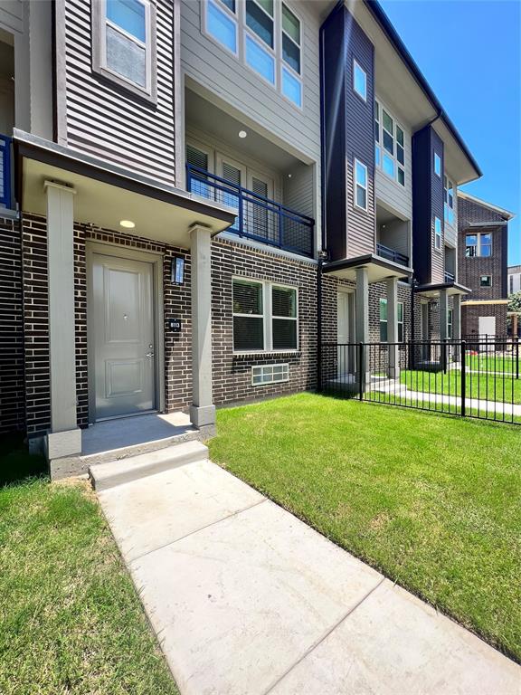 4020 McEwen Road, Unit 8113 Farmers Branch, TX 75244 - Photo 1 of 1 front view of a brick building with a yard