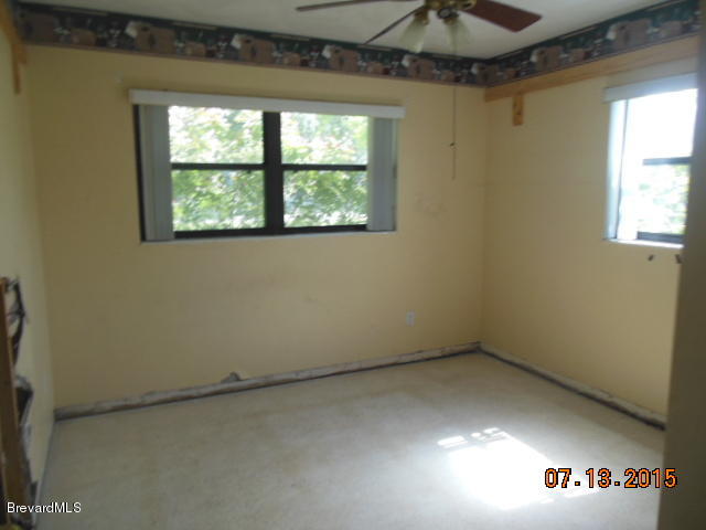 1961 Trimble Road Melbourne, FL 32934 - Photo 8 of 16 an empty room with a window