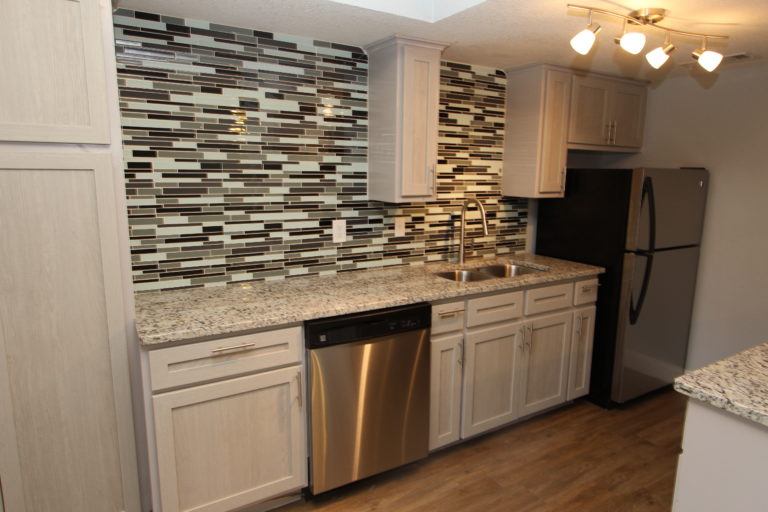 6509 Berkman Drive, Unit 106 Austin, TX 78723 - Photo 8 of 17 a kitchen with cabinets and stainless steel appliances