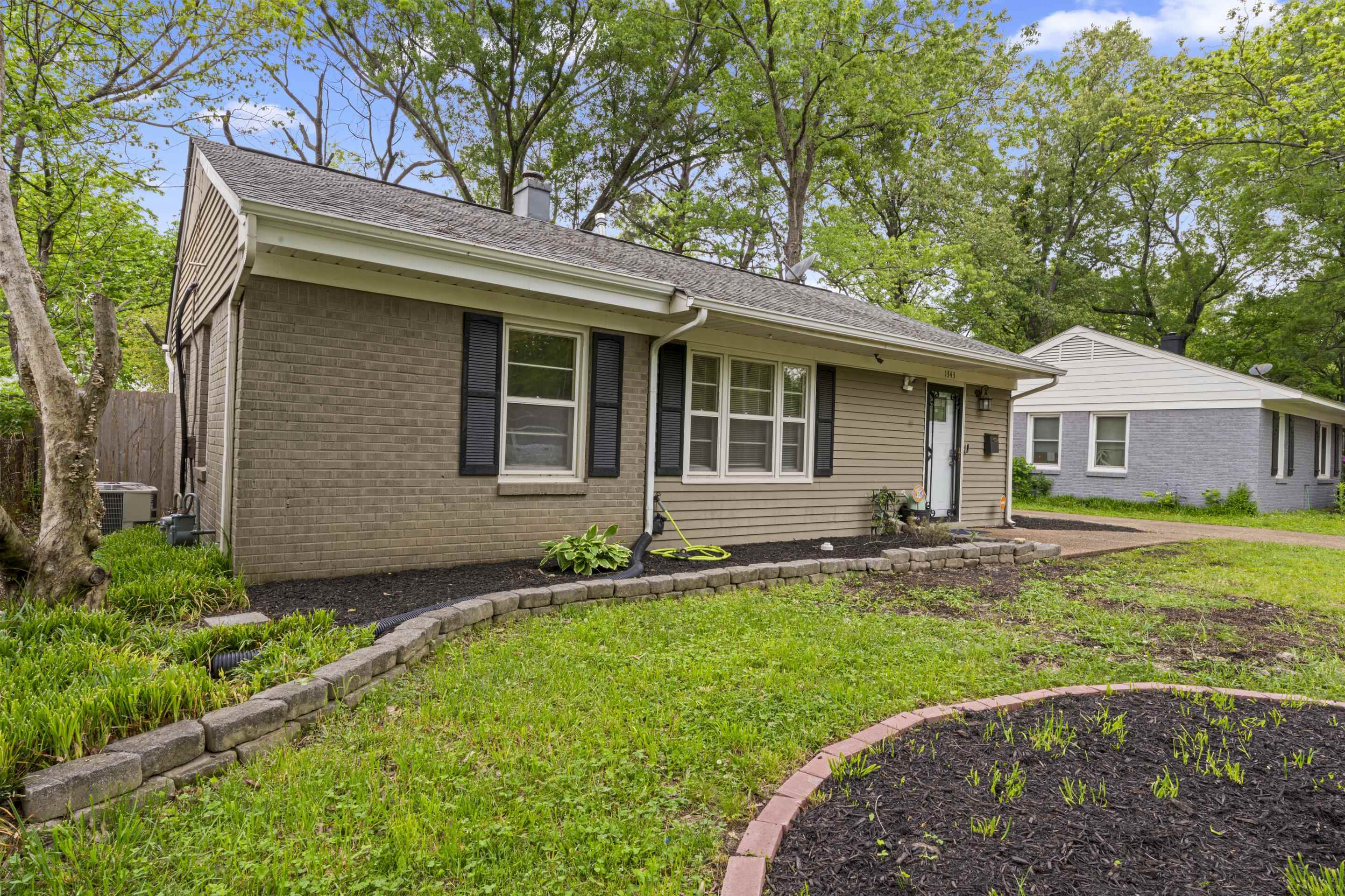 1343 Dearing Road Memphis, TN 38117 - Photo 2 of 19 Single-story residence featuring a brick and siding exterior with a dark-shingle roof