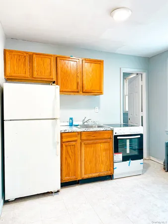 a kitchen with blue cabinets and a large window