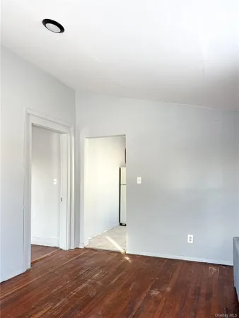 a view of an empty room and wooden floor
