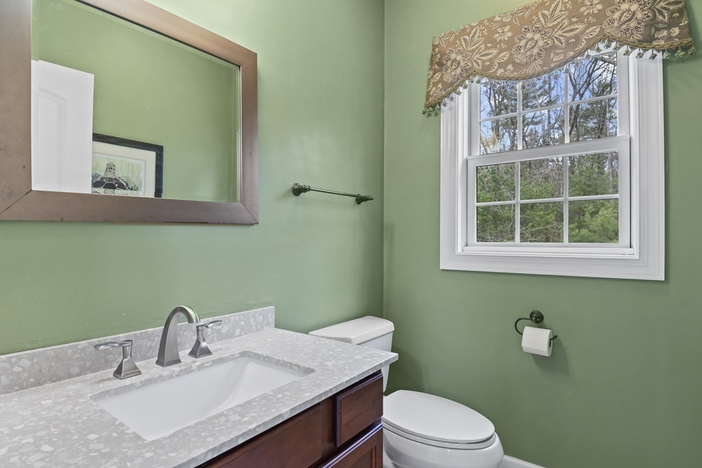 25 Wilkes Road Rowley, MA 01969 - Photo 17 of 40 a bathroom with a sink vanity mirror and toilet