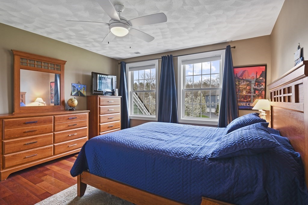 25 Wilkes Road Rowley, MA 01969 - Photo 23 of 40 a bedroom with a bed and a dresser in it