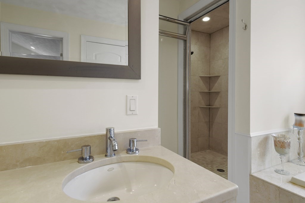 25 Wilkes Road Rowley, MA 01969 - Photo 29 of 40 a bathroom with a sink and a mirror